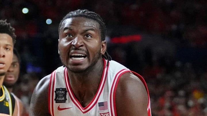 Apr 4, 2026; Indianapolis, IN, USA; Arizona Wildcats guard Jaden Bradley (0) knocks Michigan Wolverines guard Elliot Cadeau (3) to the ground during the first half in a semifinal of the Final Four of the men's 2026 NCAA Tournament at Lucas Oil Stadium. Mandatory Credit: Bob Donnan-Imagn Images