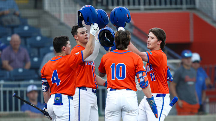 Cade Kurland (4), Luke Heyman (28) and Colby Shelton (10) celebrate with Brendan Lawson (11) after the freshman's three-run home run against Jacksonville. The Florida Gators would go on to win 16-4. Cade Kurland (4), Luke Heyman (28) and Colby Shelton (10) celebrate with Brendan Lawson (11) after the freshman's three-run home run against Jacksonville. The Florida Gators would go on to win 16-4.