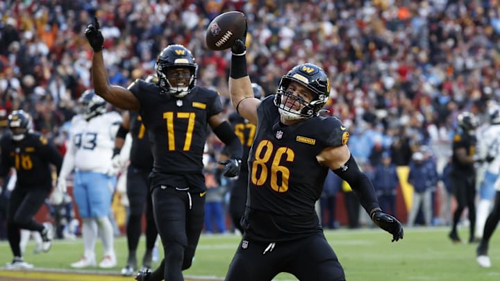 Dec 1, 2024; Landover, Maryland, USA; Washington Commanders tight end Zach Ertz (86) spikes the ball in the end zone after catching a touchdown pass as Commanders wide receiver Terry McLaurin (17) celebrates against the Tennessee Titans during the fourth quarter at Northwest Stadium. Mandatory Credit: Geoff Burke-Imagn Images