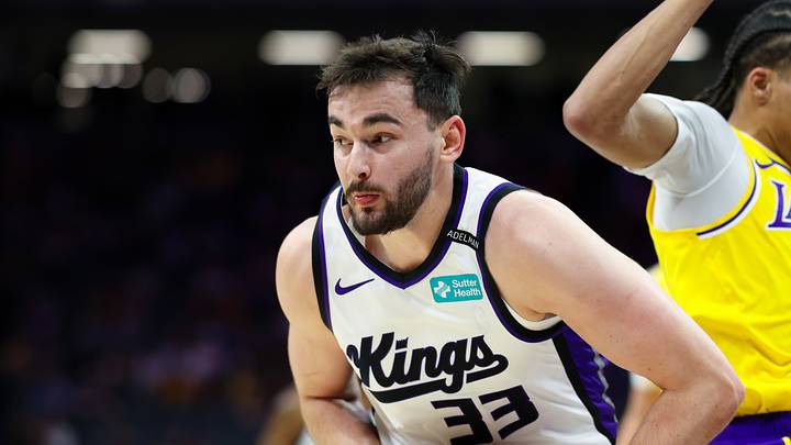 Oct 5, 2026; Sacramento, California, USA;  Sacramento Kings forward Alex Karaban (33) grabs a rebound against Los Angeles Lakers guard Cameron Carr (43) during the fourth quarter at Golden 1 Center.  Mandatory Credit: Sergio Estrada-Imagn Images