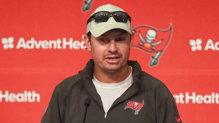 Buccaneers Offensive Coordinator Josh Grizzard speaks at podium during press conference.