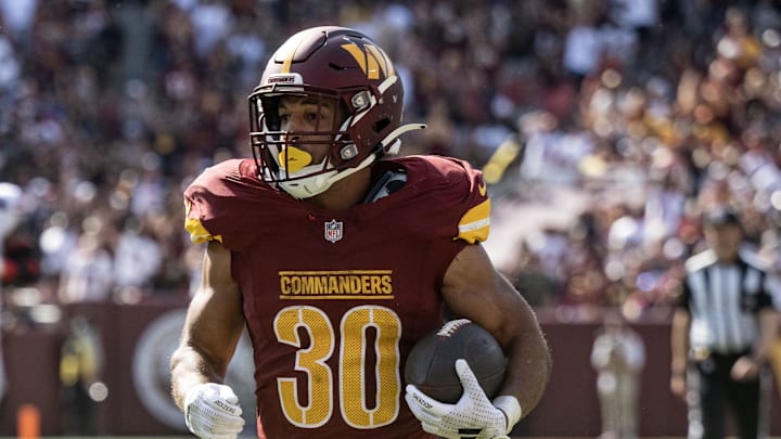 Sep 15, 2024; Landover, Maryland, USA; Washington Commanders running back Austin Ekeler (30) runs the ball for a gain after a reception in the second half against the New York Giants at Commanders Field. Mandatory Credit: Luke Johnson-Imagn Images

