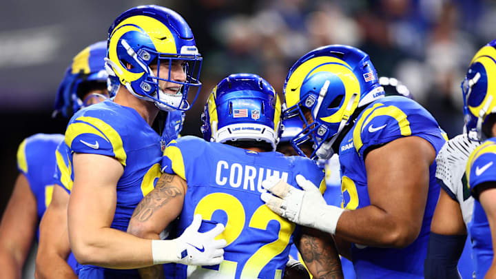 Dec 18, 2025; Seattle, Washington, USA; Los Angeles Rams running back Blake Corum (22) celebrates with quarterback Matthew Stafford (9) after a touchdown against the Seattle Seahawks in the second half at Lumen Field. Mandatory Credit: Kevin Ng-Imagn Images