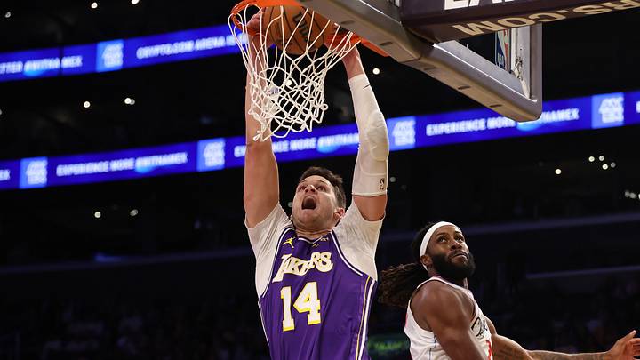 Oct 23, 2026; Los Angeles, California, USA;  Los Angeles Lakers center Walker Kessler (14) dunks the ball against Los Angeles Clippers forward Isaiah Jackson (23) during the first quarter at Crypto.com Arena. Mandatory Credit: Kiyoshi Mio-Imagn Images