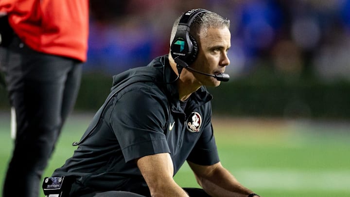Florida State Seminoles head coach Mike Norvell crouches on the sideline during the second half against the Florida Gators at Steve Spurrier Field at Ben Hill Griffin Stadium in Gainesville, FL on Saturday, November 25, 2023. [Matt Pendleton/Gainesville Sun]