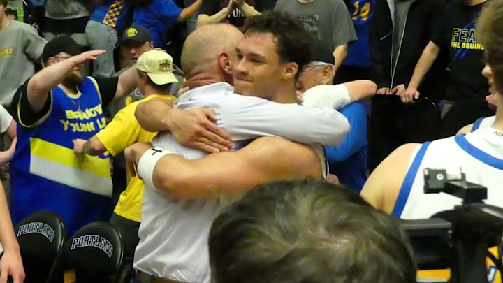 Barlow coach Tom Johnson and senior guard Jalen Atkins hug after the Bruins won the OSAA Class 6A boys basketball state championship Saturday night.