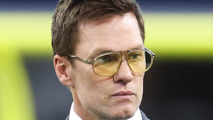 Nov 23, 2025; Arlington, Texas, USA; Former NFL quarterback Tom Brady looks on from the sideline before the game between the Philadelphia Eagles and Dallas Cowboys at AT&T Stadium. Mandatory Credit: Kevin Jairaj-Imagn Images