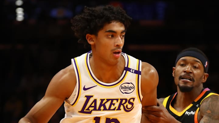 Nov 26, 2024; Phoenix, Arizona, USA; Los Angeles Lakers guard Max Christie (12) against Phoenix Suns guard Bradley Beal (3) during an NBA Cup game at Footprint Center. Mandatory Credit: Mark J. Rebilas-Imagn Images