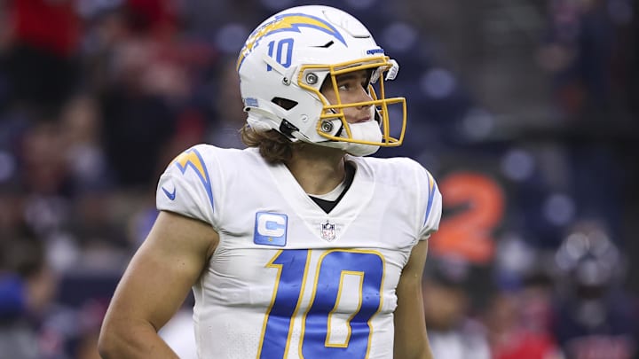 Dec 26, 2021; Houston, Texas, USA; Los Angeles Chargers quarterback Justin Herbert (10) walks off the field after a play during the fourth quarter against the Houston Texans at NRG Stadium. Mandatory Credit: Troy Taormina-Imagn Images