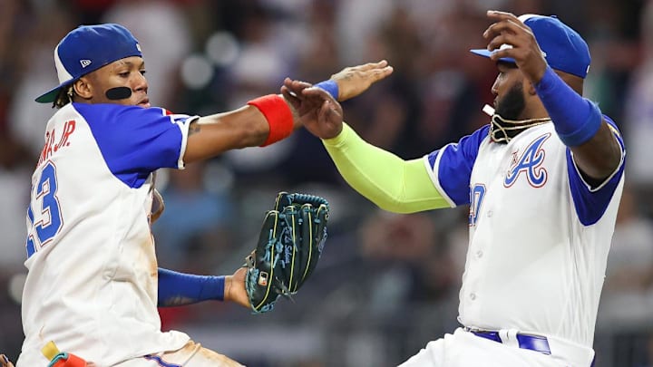 Atlanta Braves outfielder Ronald Acuna Jr. (13) and designated hitter Marcell Ozuna (20) celebrate after a victory against the Washington Nationals at Truist Park.