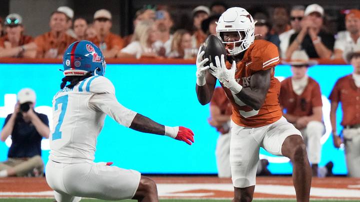 Texas Longhorns running back Derrek Cooper (5) makes a catch in front of Mississippi Rebels safety Sharif Denson (7) during the first half at Darrell K Royal-Texas Memorial Stadium. Texas Longhorns running back Derrek Cooper (5) makes a catch in front of Mississippi Rebels safety Sharif Denson (7) during the first half at Darrell K Royal-Texas Memorial Stadium.