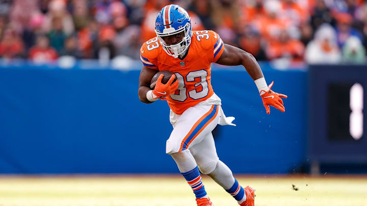 Jan 5, 2025; Denver, Colorado, USA; Denver Broncos running back Javonte Williams (33) runs the ball in the second quarter against the Kansas City Chiefs at Empower Field at Mile High. 