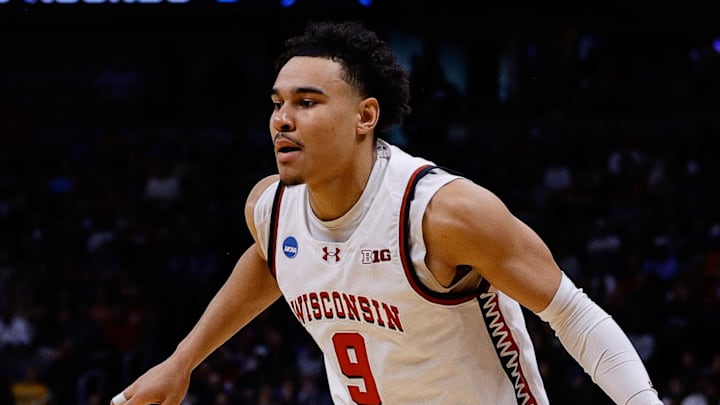 Mar 20, 2025; Denver, CO, USA; Wisconsin Badgers guard John Tonje (9) dribbles the ball against the Montana Grizzlies during the first half in the first round of the NCAA Tournament at Ball Arena. Mandatory Credit: Isaiah J. Downing-Imagn Images