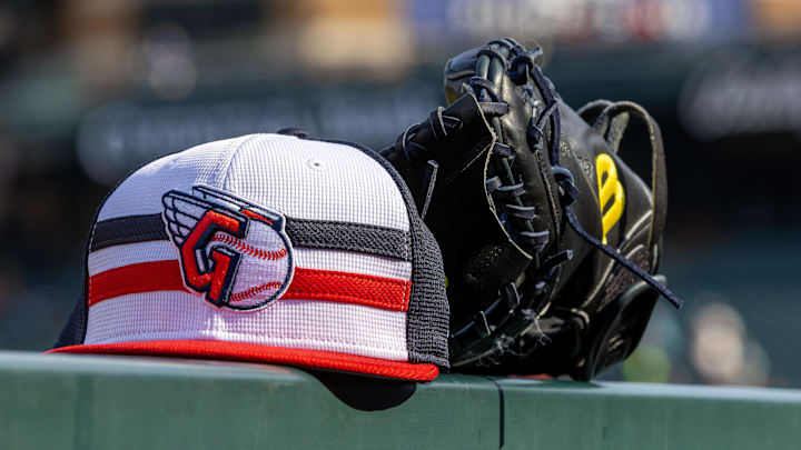 Jul 8, 2024; Detroit, Michigan, USA; A Cleveland Guardians baseball cap and glove sit on the dugout rail before the game against the Detroit Tigers at Comerica Park. Mandatory Credit: David Reginek-Imagn Images