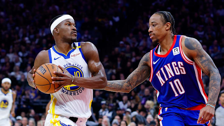 Feb 21, 2025; Sacramento, California, USA; Golden State Warriors forward Jimmy Butler III (10) drives to the basket against Sacramento Kings forward DeMar DeRozan (10) during the fourth quarter at Golden 1 Center.