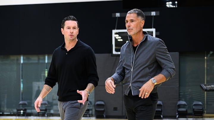 Sep 25, 2025; El Segundo, CA, USA; Los Angeles Lakers head coach JJ Redick, left, and general manager Rob Pelinka arrive to a press conference to preview the 2025-26 season at UCLA Health Training Center. Mandatory Credit: William Liang-Imagn Images