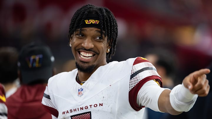 Sep 29, 2024; Glendale, Arizona, USA; Washington Commanders quarterback Jayden Daniels (5) celebrates against the Arizona Cardinals at State Farm Stadium. Mandatory Credit: Mark J. Rebilas-Imagn Images