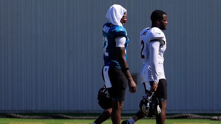 Jacksonville Jaguars wide receiver Travis Hunter (12) walks off the field with cornerback Jourdan Lewis (2) after an NFL training camp session at the Miller Electric Center, Wednesday, Aug. 6, 2025, in Jacksonville, Fla. [Corey Perrine/Florida Times-Union]