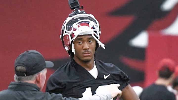 Arkansas Razorbacks quarterback Taylen Green listening to offensive coordinator Bobby Petrino in preseason practice at the indoor center in Fayetteville, Ark.