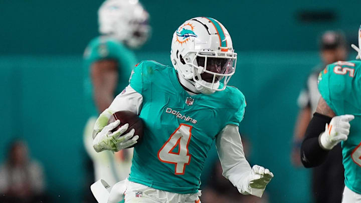 Dec 22, 2024; Miami Gardens, Florida, USA; Miami Dolphins cornerback Kader Kohou (4) runs with the ball after intercepting a pass from San Francisco 49ers quarterback Brock Purdy (13, not pictured) during second half at Hard Rock Stadium. Mandatory Credit: Jasen Vinlove-Imagn Images