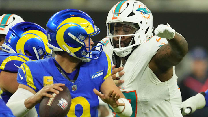 Nov 11, 2024; Inglewood, California, USA; Los Angeles Rams quarterback Matthew Stafford (9) is pressured by Miami Dolphins defensive tackle Neil Farrell (97) in the second half at SoFi Stadium. Mandatory Credit: Kirby Lee-Imagn Images