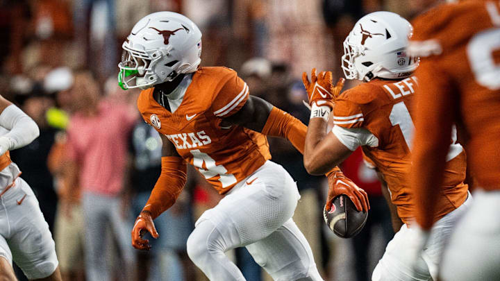Oct 19, 2024; Austin, Texas, USA; Texas Longhorns defensive back Andrew Mukuba (4) runs across the field with the ball after an interception against the Georgia Bulldogs in the first quarter at Darrell K. Royal Texas Memorial Stadium. Mandatory Credit: Sara Diggins/USA TODAY Network via Imagn Images