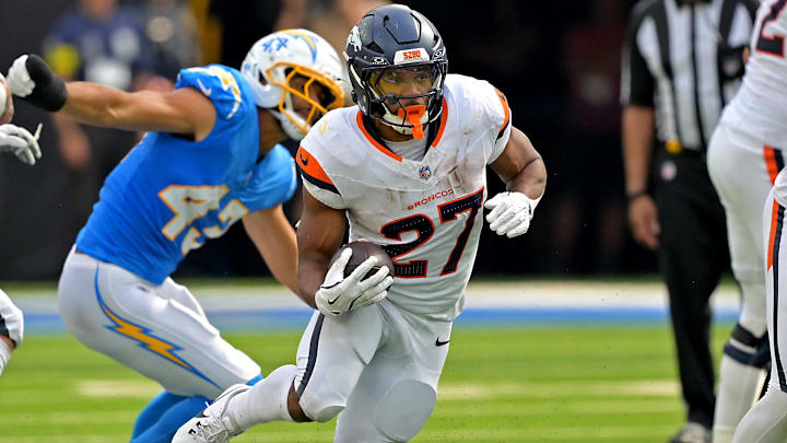 Sep 21, 2025; Inglewood, California, USA;   Denver Broncos running back J.K. Dobbins (27) carries the ball in the second half against the Los Angeles Chargers at SoFi Stadium. 