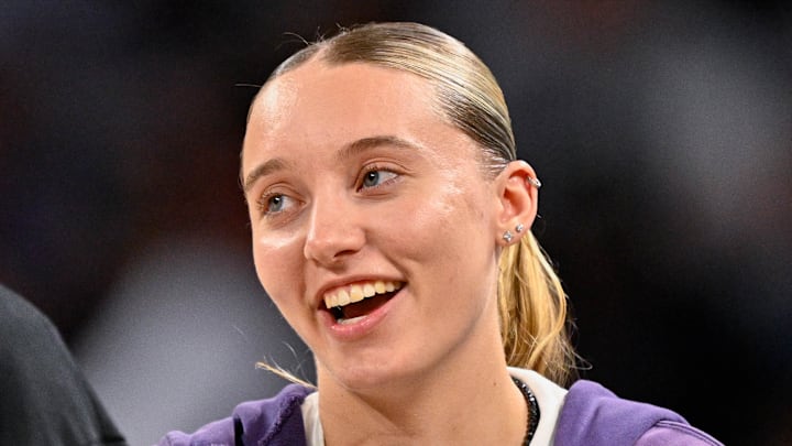 Oct 6, 2025; Fort Worth, Texas, USA; Dallas Mavericks guard Kyrie Irving (left) talks with Dallas Wings guard Paige Bueckers (right) during the second half of the game between the Mavericks and the Oklahoma City Thunder at Dickie's Arena. Mandatory Credit: Jerome Miron-Imagn Images