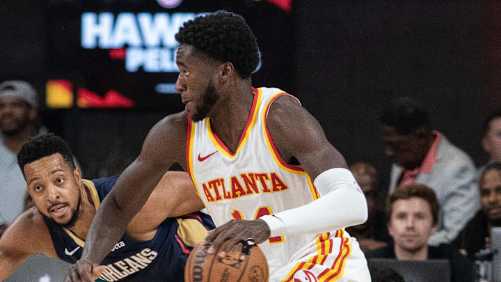 Oct 14, 2023; College Park, Georgia, USA; Atlanta Hawks forward AJ Griffin (14) drives the ball against New Orleans Pelicans guard CJ McCollum (3) during the third quarter at Gateway Center Arena at College Park. Mandatory Credit: Jordan Godfree-Imagn Images
