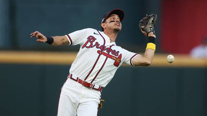 Oct 7, 2026; Cumberland, Georgia, USA;  Atlanta Braves outfielder Mauricio Dubon (14) makes an error on a hit by Los Angeles Dodgers third baseman Max Muncy (13) during the second inning in game four of the NLDS for the 2026 MLB Playoffs at Truist Park.  Mandatory Credit: Brett Davis-Imagn Images