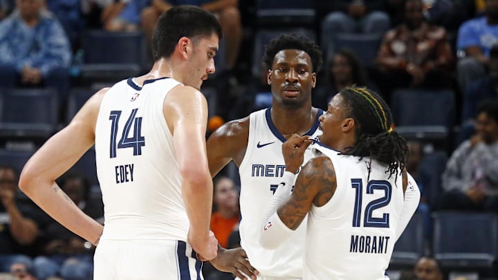 Oct 30, 2024; Memphis, Tennessee, USA; Memphis Grizzlies guard Ja Morant (12) talks with center Zach Edey (14) and forward Jaren Jackson Jr. (13) during the first half against the Brooklyn Nets at FedExForum. Mandatory Credit: Petre Thomas-Imagn Images