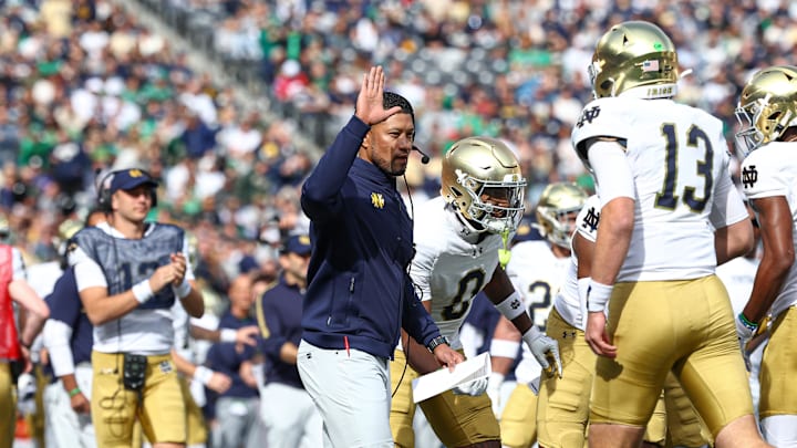 Oct 26, 2024; East Rutherford, New Jersey, USA; Notre Dame Fighting Irish head coach Marcus Freeman celebrates with teammates after a touchdown during the first half against the Navy Midshipmen at MetLife Stadium. 