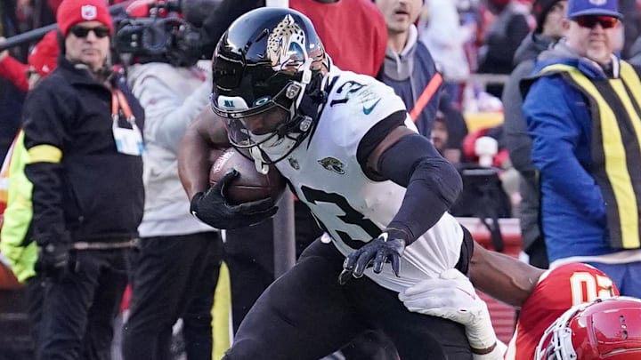Nov 13, 2022; Kansas City, Missouri, USA; Jacksonville Jaguars wide receiver Christian Kirk (13) runs the ball as Kansas City Chiefs safety Justin Reid (20) makes the tackle during the second half of the game at GEHA Field at Arrowhead Stadium. Mandatory Credit: Denny Medley-Imagn Images