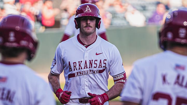 Brent Iredale with Cam Kozeal and Kuhio Aloy after hitting his seventh home run of the year against the Central Arkansas Bears. The Razorbacks won 9-2.