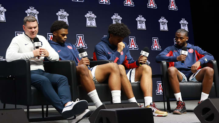 Oct 22, 2025; Kansas City, MO, USA; Arizona head coach Tommy Lloyd and players Tobe Awaka, Koa Peat and Jaden Bradley speaks to media during Big 12 Menís Basketball media day at T-Mobile Center. Mandatory Credit: Sophia Scheller-Imagn Images