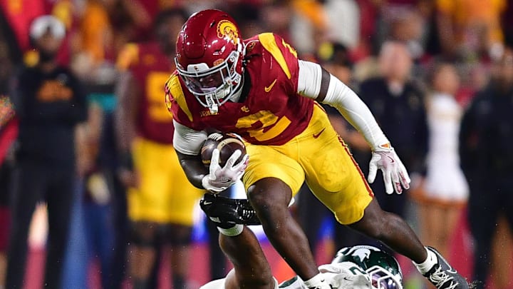 Sep 20, 2025; Los Angeles, California, USA; Southern California Trojans running back Waymond Jordan (2) runs the ball against Michigan State Spartans linebacker Darius Snow (23) during the first half at the Los Angeles Memorial Coliseum. Mandatory Credit: Gary A. Vasquez-Imagn Images