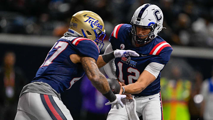Jan 27, 2026; Frisco, TX, USA; West quarterback Joe Fagnano (12) hands the ball off to running back Dom Richardson (47) during the second half at the Ford Center at the Star. Jan 27, 2026; Frisco, TX, USA; West quarterback Joe Fagnano (12) hands the ball off to running back Dom Richardson (47) during the second half at the Ford Center at the Star.