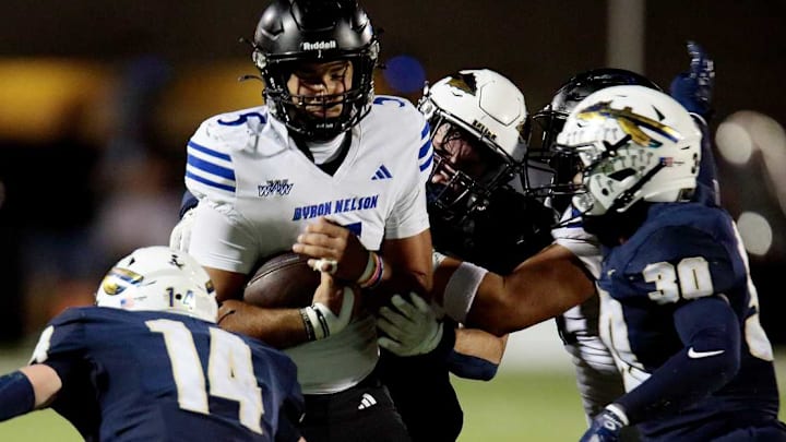 Trophy Club Byron Nelson quarterback Parker Almanza is tackled by a trio of Keller defenders in a game on Oct. 9. 