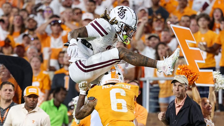 Mississippi State Bulldogs wide receiver Anthony Evans III (3) jumps over Tennessee Volunteers defensive back Jalen McMurray (6) during overtime at Davis Wade Stadium at Scott Field.