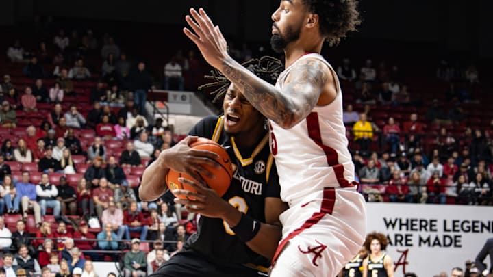 Missouri guard Anthony Robinson II (0) collides with Alabama center Noah Williamson (15) during a game at Coleman Coliseum in Tuscaloosa, Ala. on Jan. 27, 2026. 
