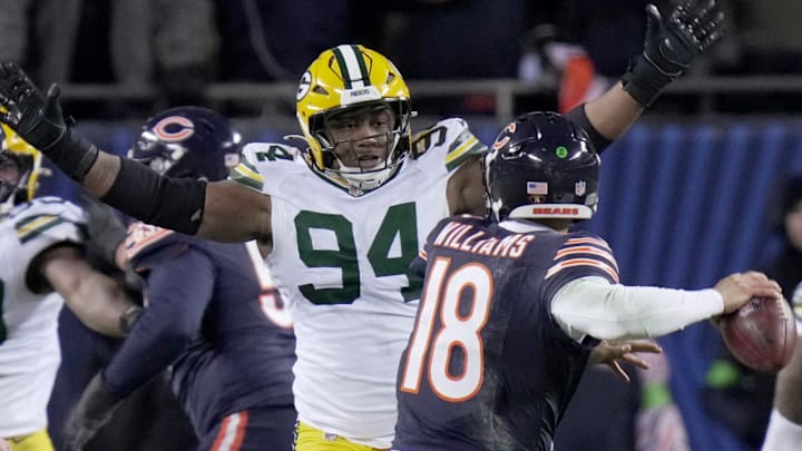 Green Bay Packers defensive end Karl Brooks (94) forces Chicago Bears quarterback Caleb Williams into an interception.