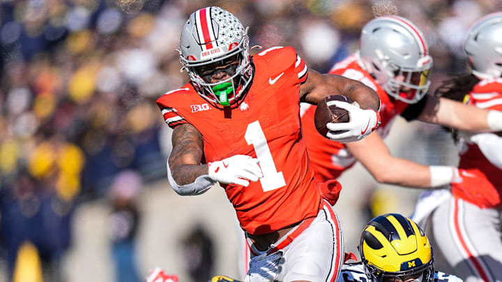 Ohio State running back Quinshon Judkins (1) runs against Michigan defensive back Wesley Walker (13) during the first half at Ohio Stadium in Columbus, Ohio on Saturday, Nov. 30, 2024. Ohio State running back Quinshon Judkins (1) runs against Michigan defensive back Wesley Walker (13) during the first half at Ohio Stadium in Columbus, Ohio on Saturday, Nov. 30, 2024.