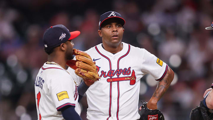 May 12, 2025; Atlanta, Georgia, USA; Atlanta Braves relief pitcher Raisel Iglesias (26) talks to second baseman Ozzie Albies (1) and catcher Sean Murphy (12) against the Washington Nationals in the ninth inning at Truist Park. Mandatory Credit: Brett Davis-Imagn Images
