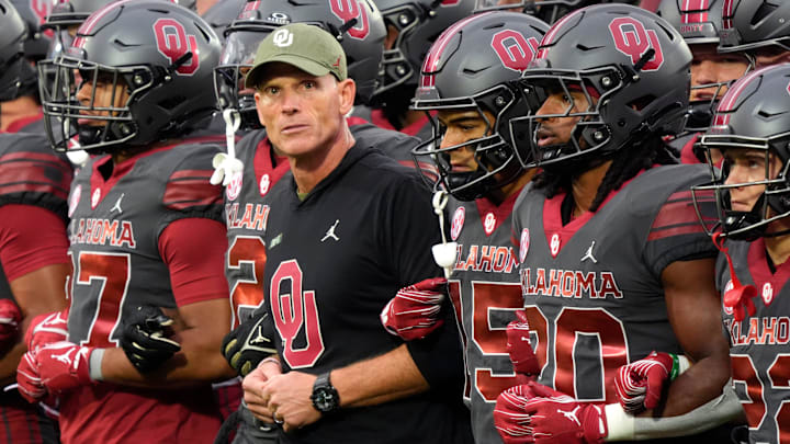 Oklahoma coach Brent Venables locks arms before the Maine game.