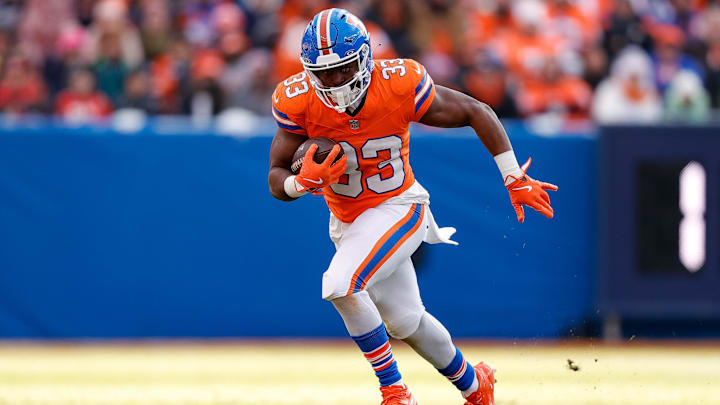Jan 5, 2025; Denver, Colorado, USA; Denver Broncos running back Javonte Williams (33) runs the ball in the second quarter against the Kansas City Chiefs at Empower Field at Mile High. 