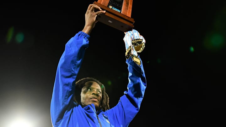 Miami Northwestern's Teddy Bridgewater raises the state trophy following the team's win over Raines in the Class 3A championship on Dec. 14, 2024.