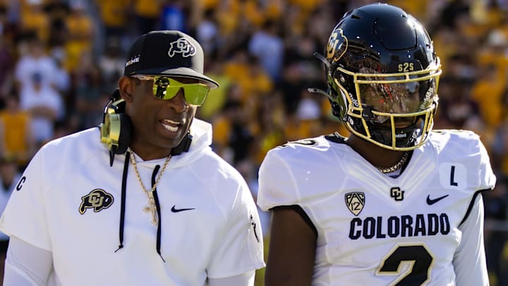 Oct 7, 2023; Tempe, Arizona, USA; Colorado Buffaloes head coach Deion Sanders with son and quarterback Shedeur Sanders (2) against the Arizona State Sun Devils at Mountain America Stadium. Mandatory Credit: Mark J. Rebilas-Imagn Images