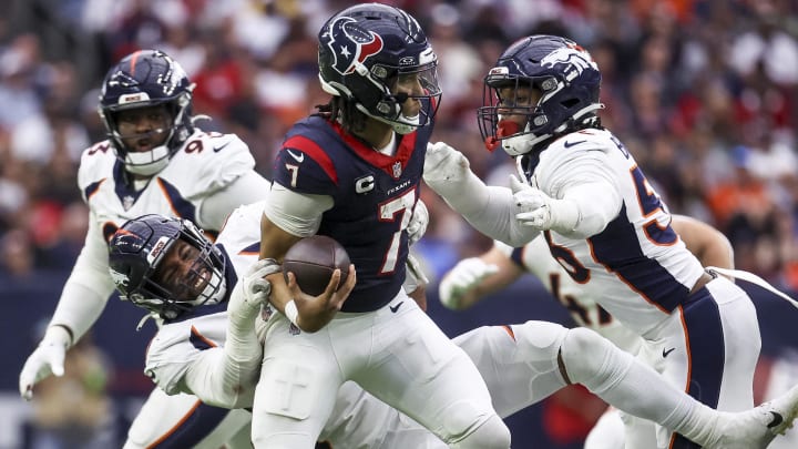 Dec 3, 2023; Houston, Texas, USA; Denver Broncos linebacker Jonathon Cooper (0) and linebacker Baron Browning (56) attempt to tackle Houston Texans quarterback C.J. Stroud (7) during the third quarter at NRG Stadium. Mandatory Credit: Troy Taormina-USA TODAY Sports