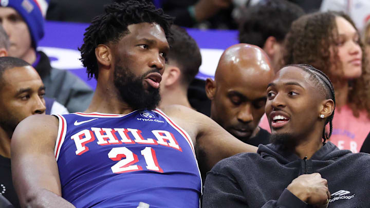 Mar 25, 2026; Philadelphia, Pennsylvania, USA; Philadelphia 76ers center Joel Embiid (21) and Tyrese Maxey (R) talk on the bench during the fourth quarter against the Chicago Bulls at Xfinity Mobile Arena. Mandatory Credit: Bill Streicher-Imagn Images