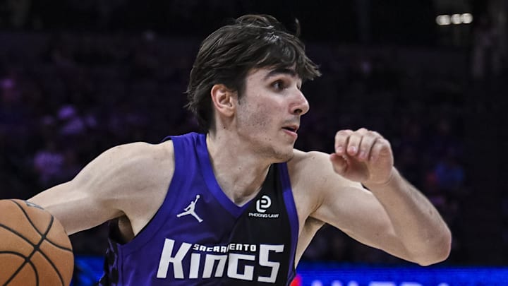 Mar 3, 2026; Sacramento, California, USA; Sacramento Kings center Maxime Raynaud (42) dribbles past Phoenix Suns forward Oso Ighodaro (11) during the fourth quarter at Golden 1 Center. Mandatory Credit: Justine Willard-Imagn Images